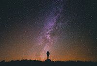 Person Standing on Rock Looking at Space